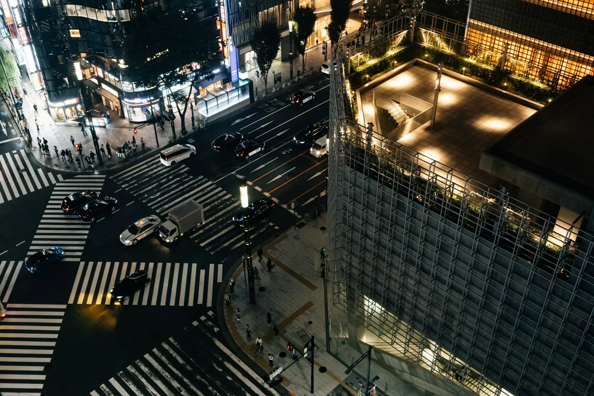 person in black suit jacket holding white tablet computer